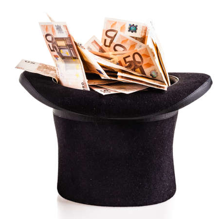 a top hat filled with fifty euro banknotes isolated over a white backgroundの写真素材