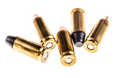 a bunch of 9mm handgun bullets cartridges isolated over a white background