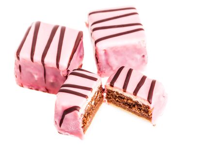 Delicious pink austrian punch cakes isolated over a white background