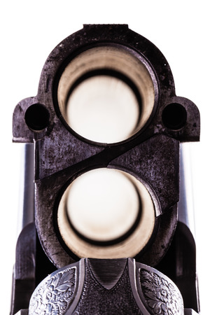 detail of the breech of a classic vertical over-under double barreled shotgun isolated over a white backgroundの写真素材