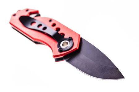 a red pocket utility knife with glass breaker and seatbelt cutter isolated over a white backgroundの写真素材