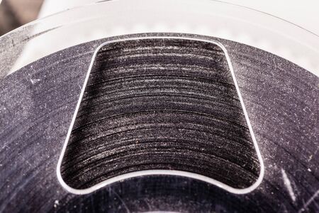 detail of an old magnetic tape reel on a white surfaceの写真素材