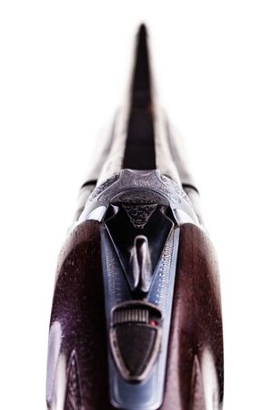a classic vertical over-under double barreled shotgun isolated over a white background