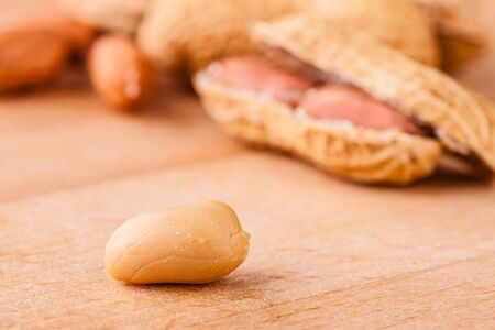 a bunch of ripe peanuts on a wooden cutting board