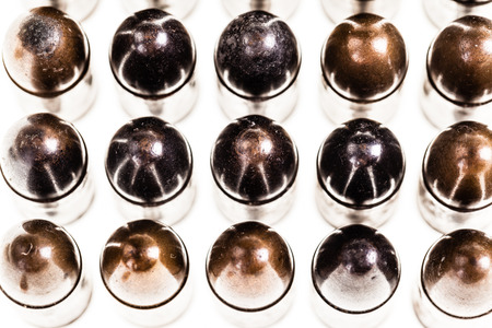 a lot of old handgun pistol bullets ammo isolated over a white background