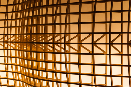 architectural detail of a wooden structure illuminated by a warm lightの写真素材