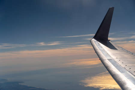 VIew of Airplane Wing With Sunset in the background