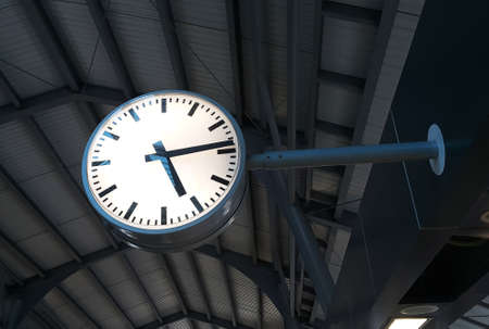 Low angle view of clock at the train station on dark background. Train time clock in the evening.