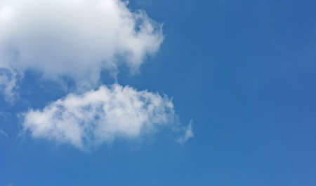 White cloud on the clear blue sky on a sunny day. Blue background with white fluffy cloud.