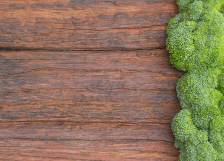 Fresh broccoli on the wood board for cookingの写真素材