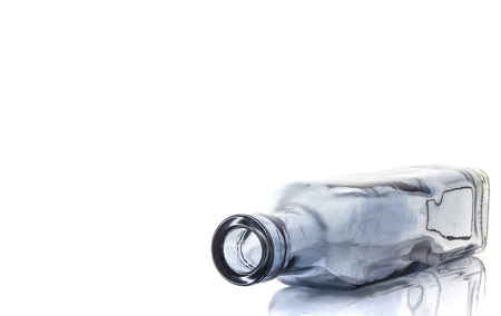 Empty transparent glass bottle isolated on a white backgroundの写真素材