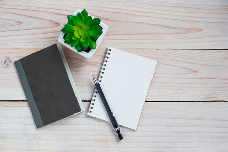 Office desk table with note paper and flower. Top view with copy space