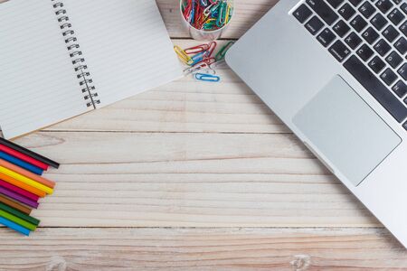 office supplies and gadgets on a wooden table background, View from above.の写真素材