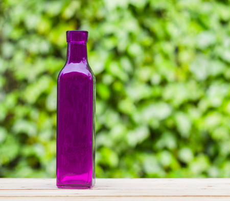 Colorful bottle with wooden table  on bright background.の写真素材