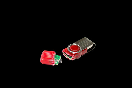 Broken USB flash drive isolated on black background