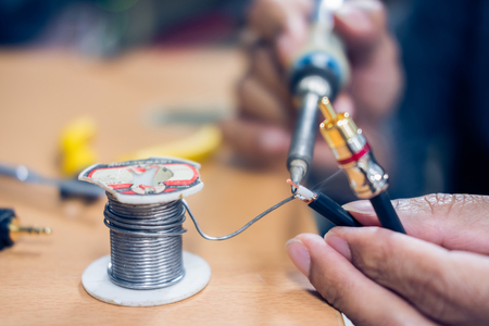 Closeup of soldering RCA cable, Repair and adjustment of the equipment on the tableの写真素材