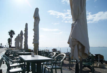 closed umbrellas facing the seaのeditorial素材