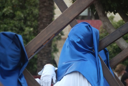 Nazarenes in the procession carrying crosses