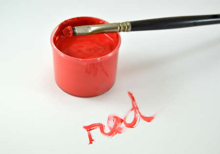 Red paint with red word written on a tableの写真素材