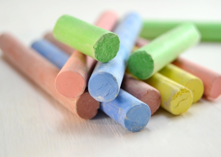Soft colored chalks on white wooden backgroundの写真素材