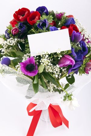 Beautiful bouquet of flowers with blank white card to put your message.の写真素材