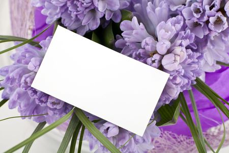 Beautiful bouquet of flowers with blank white card to put your message.の写真素材