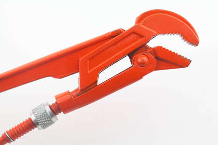 Orange pipe wrench on white background の写真素材