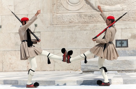 ATHENS, GREECE - JULY 23: Evzones (presidential guards) watches over the monument of the Unknown Soldier in front of the Greek Parliament Building at Syntagma Square on July 23, 2010 in Athens, Greece. Evzoni, is the name of historical elite mountain unitのeditorial素材