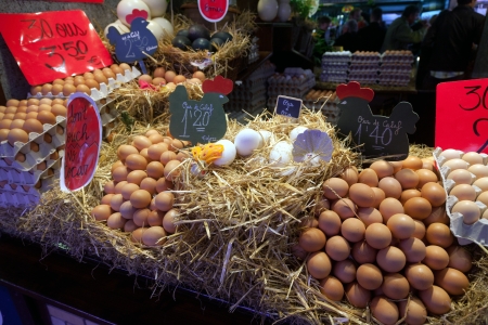 BARCELONA, SPAIN - APRIL 14: Tourists shop with eggs in famous La Boqueria market on April 14, 2012 in Barcelona, Spain. One of the oldest markets in Europe that still exist. Established 1217.のeditorial素材