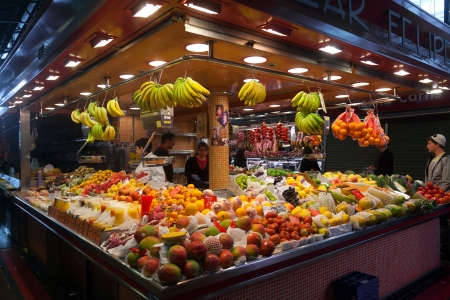 BARCELONA, SPAIN - APRIL 14: Tourists shop in famous La Boqueria market on April 14, 2012 in Barcelona, Spain. One of the oldest markets in Europe that still exist. Established 1217.のeditorial素材