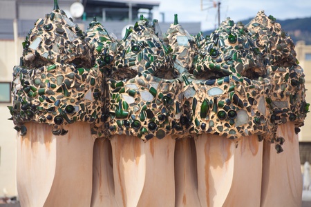 BARCELONA, SPAIN ? APR 14: Chimneys like masked soldiers on the roof of La Pedrera or Casa Mila designed by Antoni Gaudi, on April 14, 2012 in Barcelona, Spain. La Pedrera was built in 1906-1910.のeditorial素材