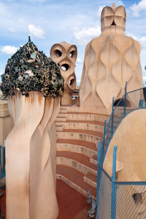 BARCELONA, SPAIN ? APR 14: Chimneys like masked soldiers on the roof of La Pedrera or Casa Mila designed by Antoni Gaudi, on April 14, 2012 in Barcelona, Spain. La Pedrera was built in 1906-1910.のeditorial素材