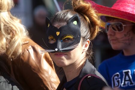 ALEXANDROUPOLIS, GREECE - FEB 25: Unidentified participant of carnival parade in Alexandroupolis on February 25, 2012 in Evros, Alexandroupolis, Greece. Young girl wearing a black mask.のeditorial素材
