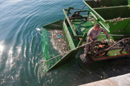 THESSALONIKI, GREECE - OCTOBER 26: Water surface cleaning boat removing the garbage from the sea in...