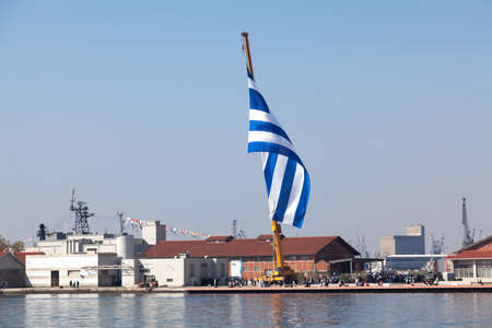 THESSALONIKI,GREECE-OCT.26: The biggest Greek flag ever built, area 480 square meters waving in the celebrations for the centenary of the liberation of the city on Oct 26,2012 in Thessaloniki, Greeceのeditorial素材