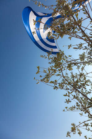 The biggest Greek flag ever built, area 480 square meters and weighing 130 kg waving in the celebrations for the centenary of the liberation of the city on Oct 26,2012 in Thessaloniki, Greeceのeditorial素材