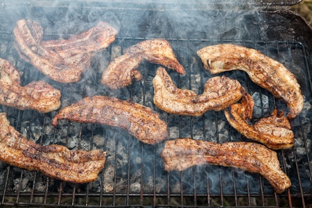 Barbecue with grilled slices of belly pork coated with a herb-rich marinadeの写真素材
