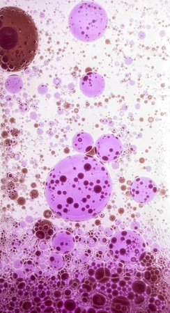 Oil drops in colorful formations on water surfaceの写真素材