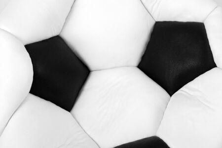 Deflated soccer ball isolated on whiteの写真素材