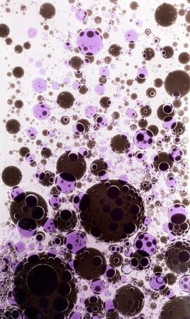 Oil drops in colorful formations on water surfaceの写真素材