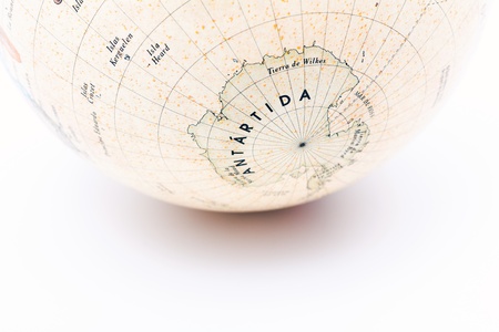 Part of a globe with map of South Pole isolated on white backgroundの写真素材
