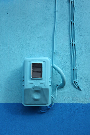 Electricity meter painted blue in harmony with the wall in Greeceの写真素材
