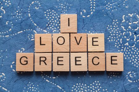 Wooden letters spelling I LOVE GREECE on blue backgroundの写真素材