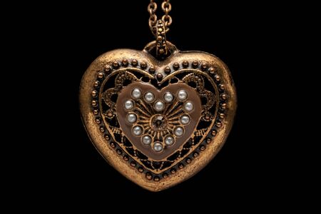 Heart-shaped necklace on black backgroundの写真素材