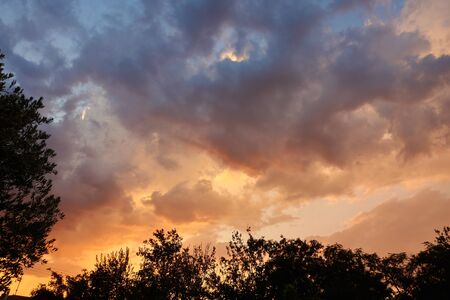 Dramatic and moody pink, purple and blue cloudy sunset sky