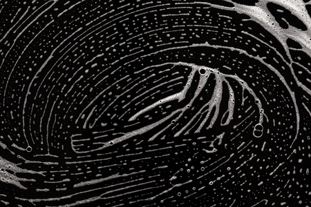 Cleaning lather. Foam laying on black background.の写真素材