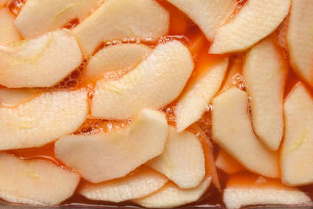 Red wet apple slices within a fruit punch. Food backgroundの写真素材