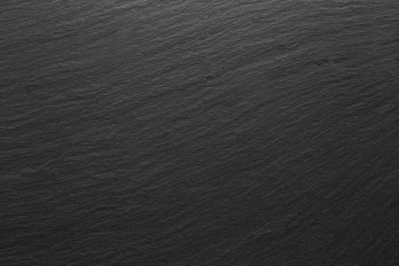 Dark grey black slate stone background or textureの写真素材