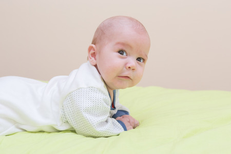 Portrait of a four-month boy. First time that raises its head.