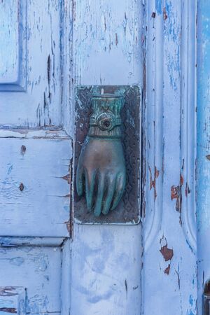 Vintage old door with handle in hand shapeの写真素材